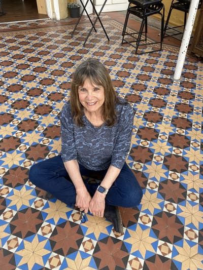 Annie Elliot sitting on the tiles at Gad's Hill Place