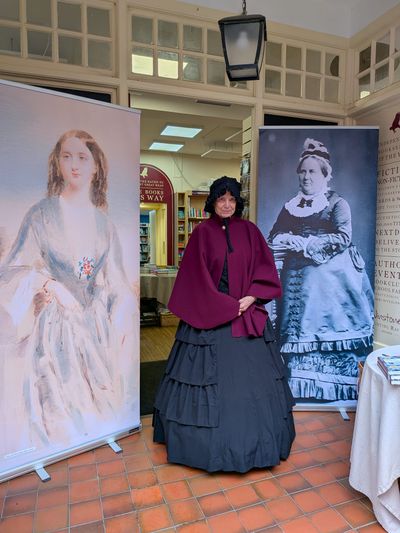 Annie Elliot as Mrs Dickens outside The Hunting Raven bookshop